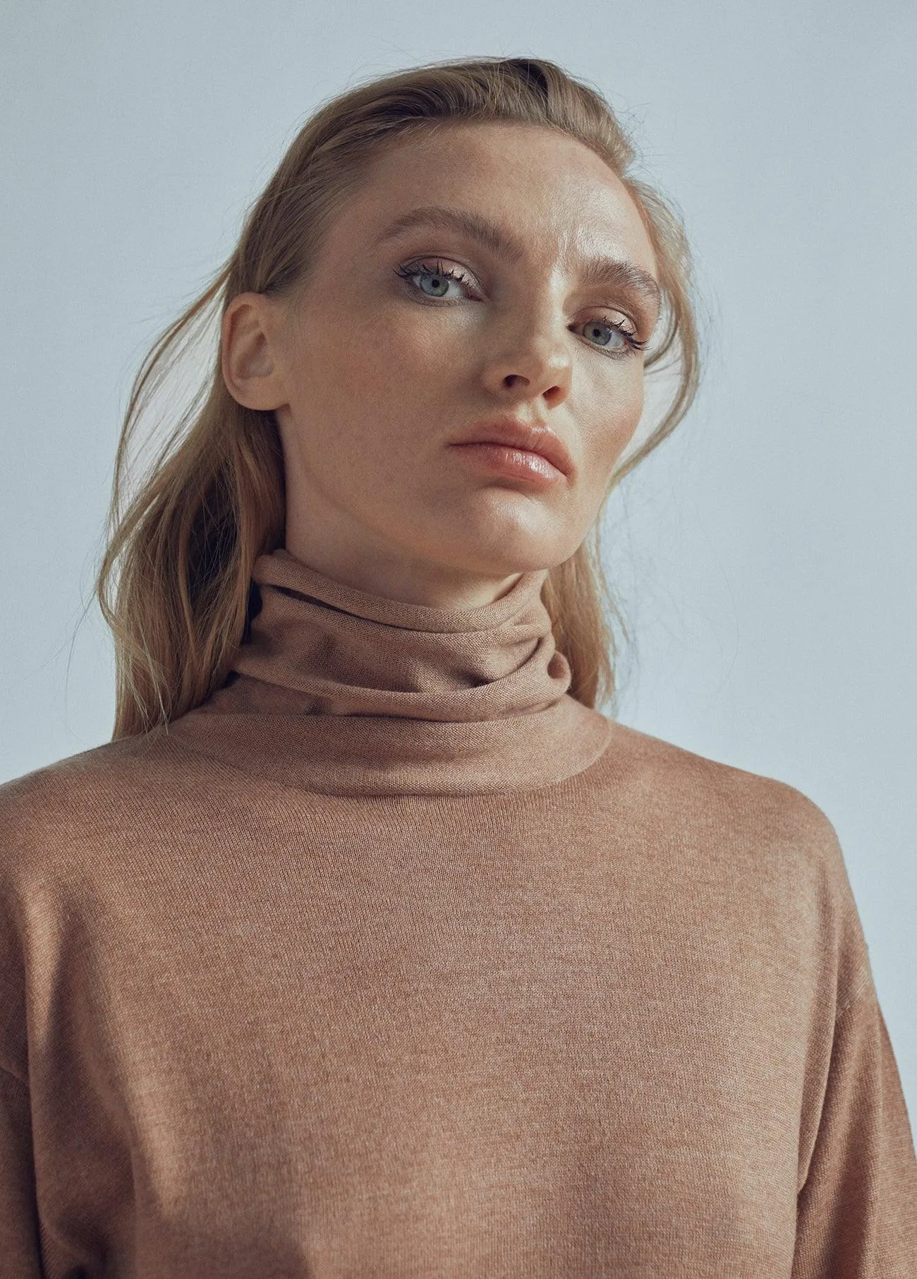 Long sweater with a high collar and slit detail